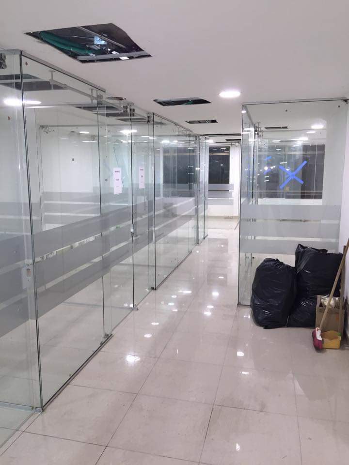 Corredor de oficinas con divisiones en vidrio